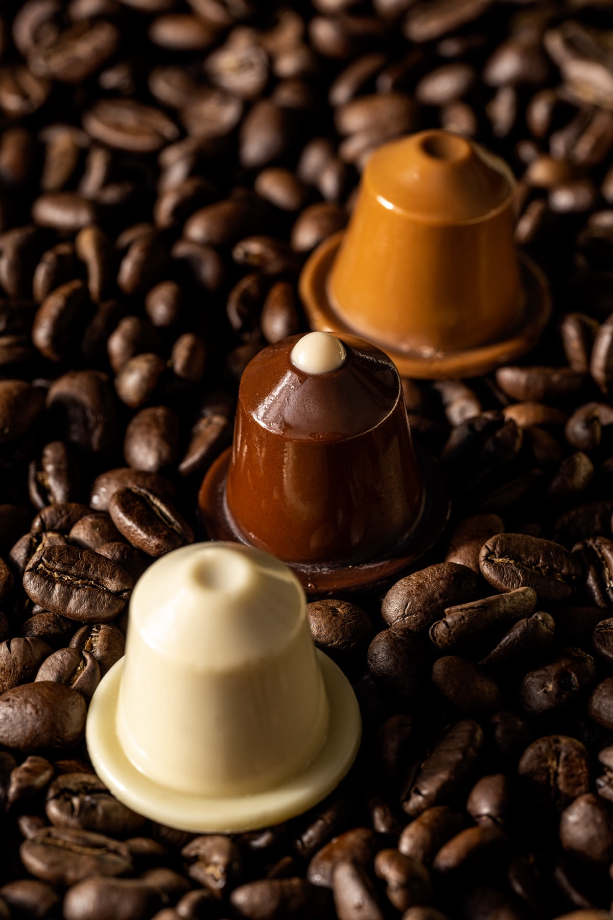 Capsules en chocolat CAPSULATE sur lit de grains de café